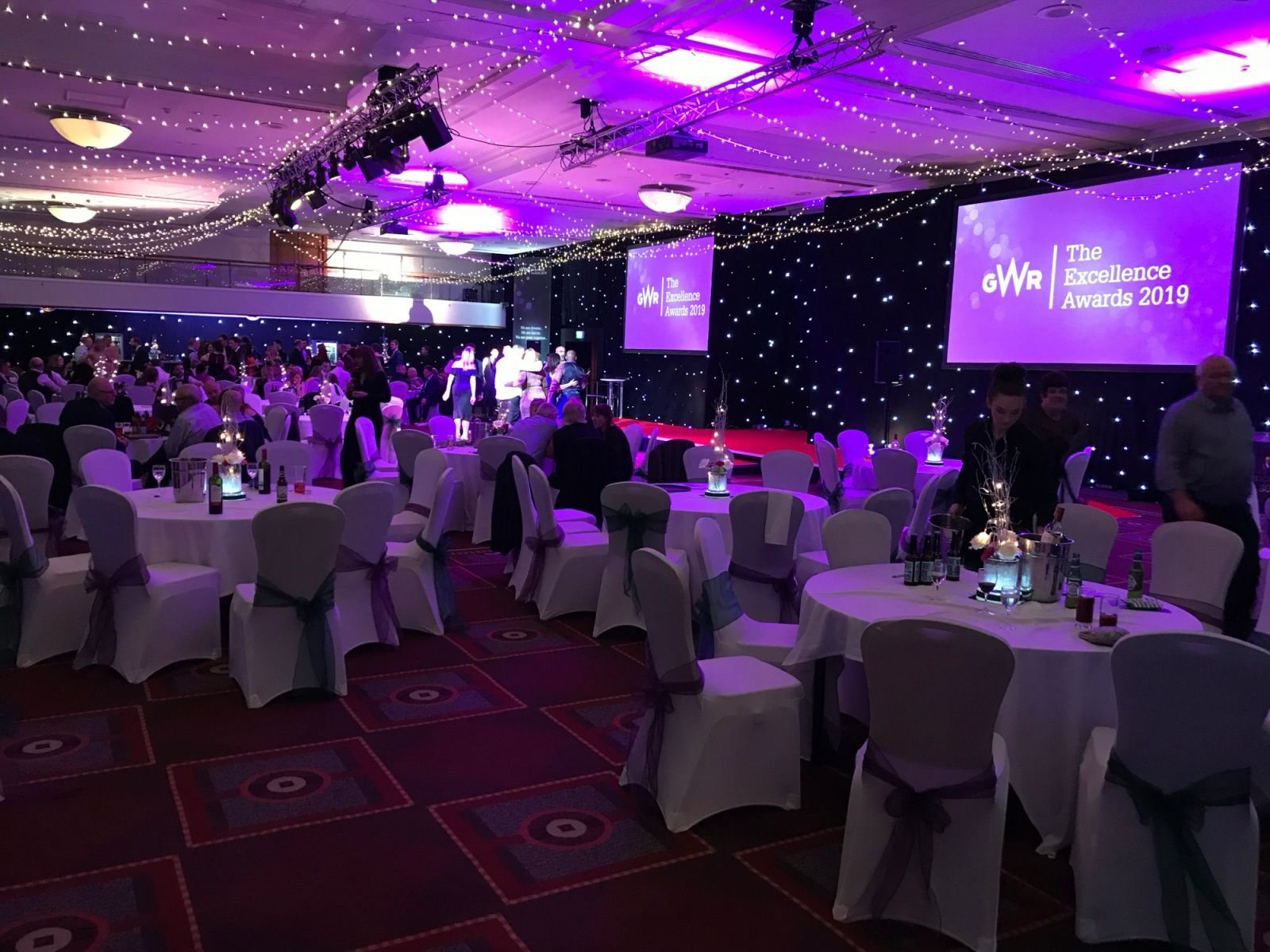 Awards ceremony ballroom dressed with black LED starcloth & purple uplighting